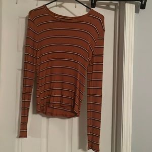 long sleeve darker shade of orange with black and white strips